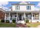 Charming two-story commercial building with a wraparound porch, adorned with string lights and lush landscaping at 238 Dorothy Ln, Lawrenceville, GA 30046
