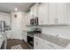 Modern kitchen with white cabinets, stainless steel appliances, and granite countertops at 238 Dorothy Ln, Lawrenceville, GA 30046