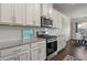 Modern kitchen with white cabinets, stainless steel appliances, and granite counters at 238 Dorothy Ln, Lawrenceville, GA 30046