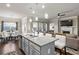 Open concept kitchen with island seating, granite countertops, and pendant lighting at 238 Dorothy Ln, Lawrenceville, GA 30046