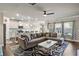 Open-concept living room and kitchen with hardwood floors, a large sectional sofa, and modern appliances at 238 Dorothy Ln, Lawrenceville, GA 30046