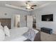Bright main bedroom boasts a ceiling fan, neutral paint, and access to the bathroom and seating area at 238 Dorothy Ln, Lawrenceville, GA 30046