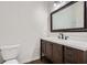 Bathroom with a wooden vanity with a mirror hanging above it, white countertop, and drawers at 2939 Owens Point Nw Trl, Kennesaw, GA 30152