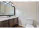 Bathroom with an undermount sink, dark wood vanity with drawers and cabinet, and a framed mirror at 2939 Owens Point Nw Trl, Kennesaw, GA 30152