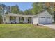 Charming one-story home with a well-manicured lawn and attached two-car garage at 2939 Owens Point Nw Trl, Kennesaw, GA 30152
