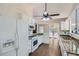 The bright kitchen features white cabinets, granite counters, and modern appliances at 2939 Owens Point Nw Trl, Kennesaw, GA 30152
