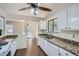Bright kitchen features granite countertops, white cabinets, and stainless steel appliances at 2939 Owens Point Nw Trl, Kennesaw, GA 30152