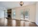 Living room with a stone fireplace, tile floors and french doors to backyard at 2939 Owens Point Nw Trl, Kennesaw, GA 30152