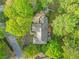 Aerial view shows house with patio furniture, well manicured lawn, landscaping and trees at 315 Mossy Pointe, Duluth, GA 30097