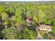 An aerial view of a home with lush landscaping and mature trees in a quiet neighborhood setting at 315 Mossy Pointe, Duluth, GA 30097