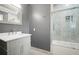 A gray bathroom boasts a combined shower and tub with tiled walls, a bright white countertop, and modern fixtures at 315 Mossy Pointe, Duluth, GA 30097