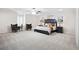 The bedroom is spacious, with neutral colors, and features two accent chairs, lamps, and nightstands at 315 Mossy Pointe, Duluth, GA 30097