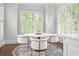 Bright breakfast nook featuring large windows, hardwood floors, and charming design at 315 Mossy Pointe, Duluth, GA 30097