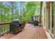 Entertain on the deck featuring a built-in grilling station and dining set to enjoy the outdoor scenery at 315 Mossy Pointe, Duluth, GA 30097