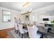 Elegant dining room featuring hardwood floors, stylish lighting, and luxurious design at 315 Mossy Pointe, Duluth, GA 30097
