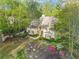 Charming home surrounded by colorful flowerbeds and mature trees, showcasing curb appeal at 315 Mossy Pointe, Duluth, GA 30097