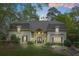 Stately home with manicured lawn, lush landscaping, and charming architectural details at 315 Mossy Pointe, Duluth, GA 30097