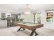 Spacious game room features a pool table, bar, recessed lighting, and doors to the backyard at 315 Mossy Pointe, Duluth, GA 30097