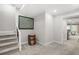 View of the carpeted hallway with white trim, staircase, and an open doorway to the living room at 315 Mossy Pointe, Duluth, GA 30097