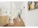 Spacious hallway with hardwood floors, elegant columns, and view to kitchen and dining areas at 315 Mossy Pointe, Duluth, GA 30097