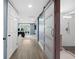 Hallway showcasing a modern design with barn doors and leading to a well-lit office and bathroom at 315 Mossy Pointe, Duluth, GA 30097