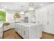 Stunning white kitchen featuring a large island, marble countertops, and gold fixtures at 315 Mossy Pointe, Duluth, GA 30097