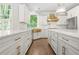 Beautiful white kitchen with marble countertops, gold hardware, and stainless steel appliances at 315 Mossy Pointe, Duluth, GA 30097
