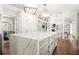 Open kitchen with large island, marble countertops, and views of living and dining areas at 315 Mossy Pointe, Duluth, GA 30097