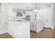 Bright kitchen with large island, white cabinetry, marble countertops, and stainless steel appliances at 315 Mossy Pointe, Duluth, GA 30097