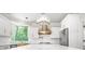 Gorgeous kitchen features marble counters, an island, stainless steel appliances and open view at 315 Mossy Pointe, Duluth, GA 30097