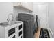 Practical laundry room equipped with a sink, cabinetry, and a modern washer and dryer at 315 Mossy Pointe, Duluth, GA 30097