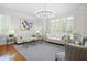 The bright living room features hardwood floors, large windows, and is tastefully decorated at 315 Mossy Pointe, Duluth, GA 30097