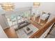 Bright living room with hardwood floors, an open layout, French doors to a patio, and modern lighting at 315 Mossy Pointe, Duluth, GA 30097