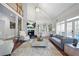 Bright living room with fireplace, soaring ceilings, and walls of windows at 315 Mossy Pointe, Duluth, GA 30097
