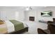 Spacious main bedroom with neutral tones, a cozy seating area, and a large television for relaxation at 315 Mossy Pointe, Duluth, GA 30097