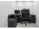 Office featuring a black desk, office chair, multiple monitors, and a printer against a neutral wall at 315 Mossy Pointe, Duluth, GA 30097