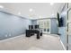 Bright office space with large windows, carpet floors, a black desk, and a wall-mounted television at 315 Mossy Pointe, Duluth, GA 30097