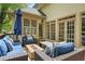 Outdoor patio with comfortable seating, a fire pit, and a view of the surrounding trees at 315 Mossy Pointe, Duluth, GA 30097