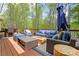 Inviting outdoor patio with comfortable seating, a modern fire pit, and lush greenery, creating a relaxing ambiance at 315 Mossy Pointe, Duluth, GA 30097