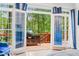Outdoor patio with outdoor grill, wooden deck, and view of surrounding trees seen from indoors at 315 Mossy Pointe, Duluth, GA 30097