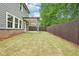 Well-manicured backyard features an outdoor living space and privacy fence at 4785 Marjorie Dr, Cumming, GA 30041