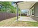 A backyard with manicured lawn, privacy fence, and patio provides an outdoor oasis at 4785 Marjorie Dr, Cumming, GA 30041