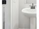 The bathroom features a white pedestal sink and a white door with black hardware at 4785 Marjorie Dr, Cumming, GA 30041