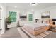 Staged bedroom with a bed, dresser, rug, plant and two windows at 4785 Marjorie Dr, Cumming, GA 30041