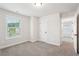 Bright bedroom featuring a carpeted floor, white walls, a window and a door at 4785 Marjorie Dr, Cumming, GA 30041