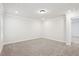 A bright bedroom showcasing neutral walls, plush carpeting, and a well-lit ambiance at 4785 Marjorie Dr, Cumming, GA 30041