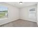 This bedroom features neutral carpet and natural light from the windows at 4785 Marjorie Dr, Cumming, GA 30041
