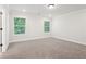 Bright bedroom featuring a carpeted floor, white walls, crown molding and large windows at 4785 Marjorie Dr, Cumming, GA 30041