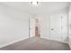This bedroom features neutral carpet, two entry doors, and natural light from the windows at 4785 Marjorie Dr, Cumming, GA 30041