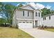 Attractive two-story house with a two-car garage, stone accents, and a meticulously landscaped front yard at 4785 Marjorie Dr, Cumming, GA 30041